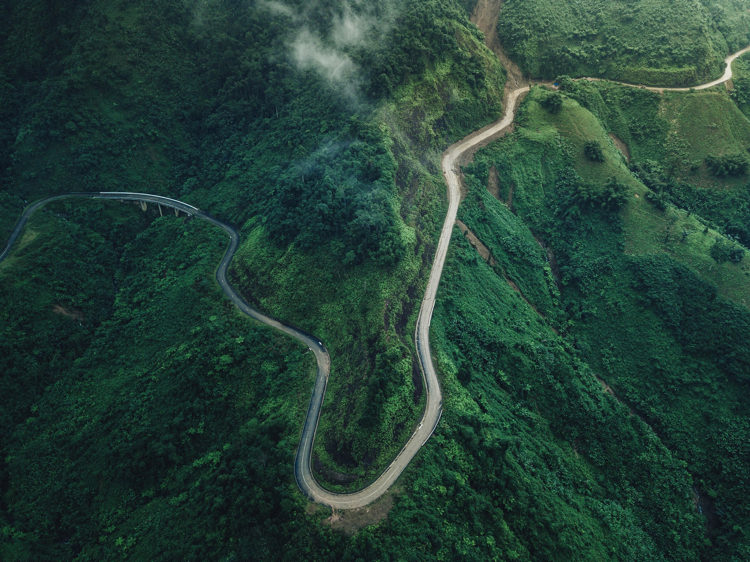 Full photo of hairpin turn in the mountains by Silas Baisch